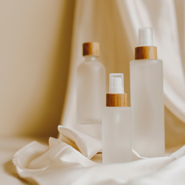 What are the benefits of using frosted glass bottles for cosmetics?