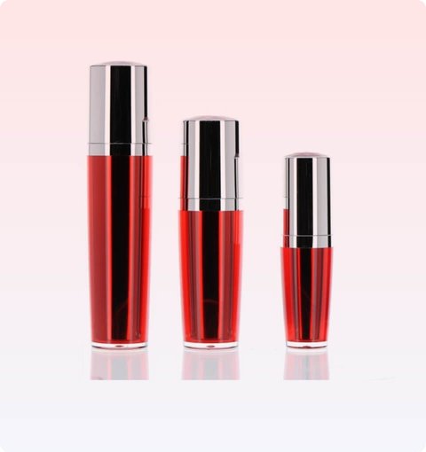 Three red lacquered lotion pump bottles in graduated sizes with silver caps